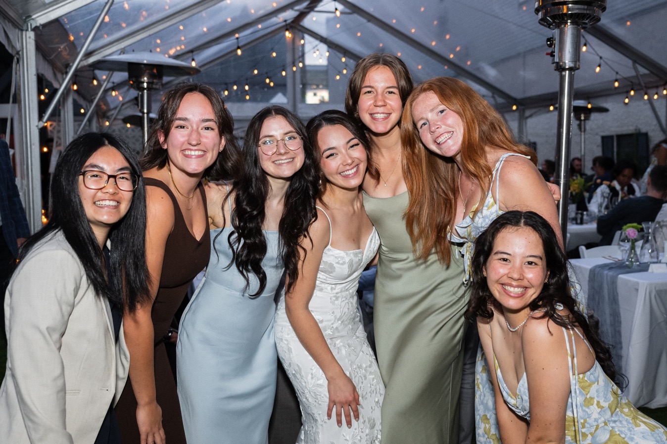 Friends gathered with the bride under the tent